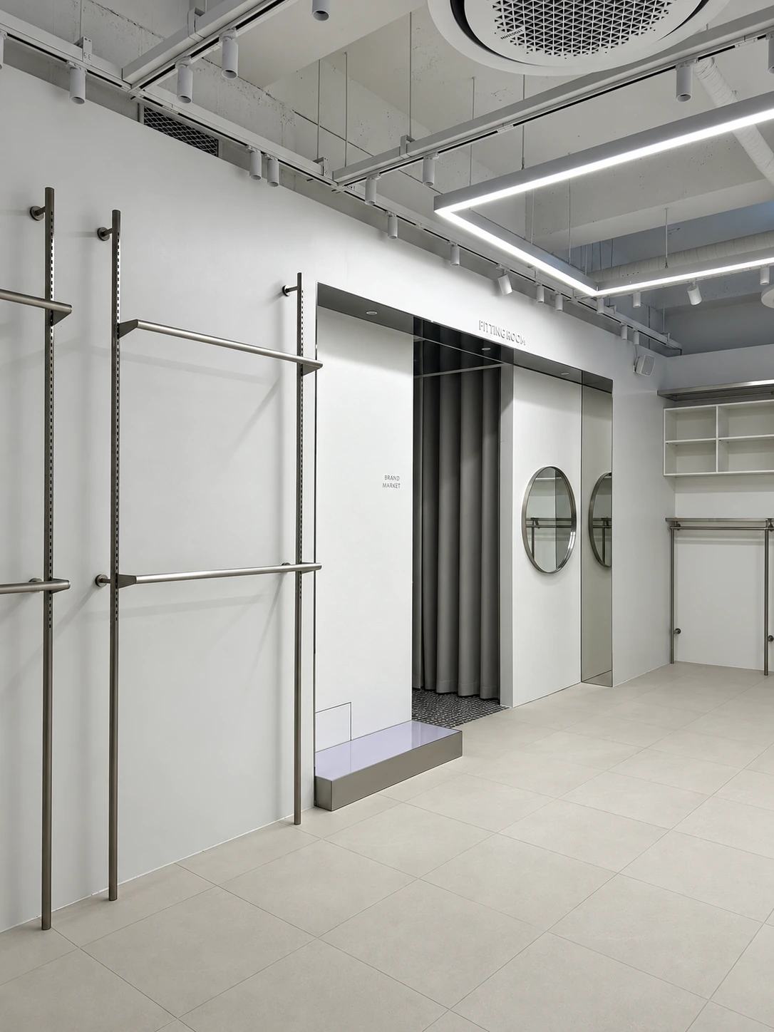 Metal fitting rooms and round mirrors