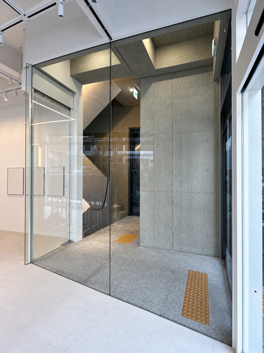 Glass entrance and concrete stair lobby