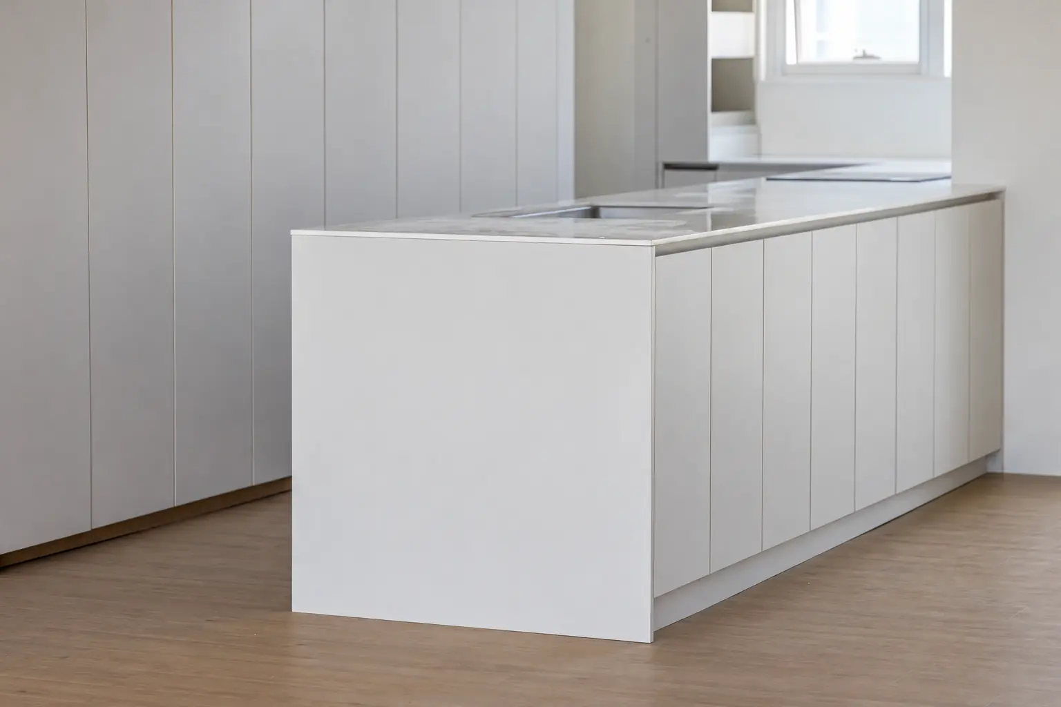 Kitchen island with adjacent matching tall cabinet finish; digitally visualized finish