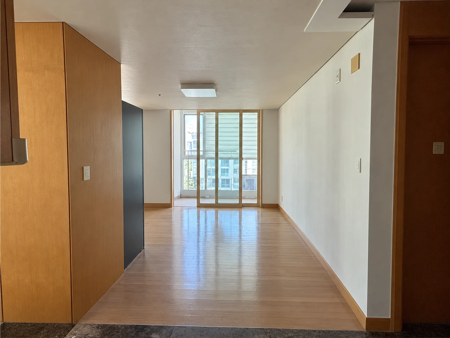 Kitchen before construction; people, loose belongings and measurements digitally removed