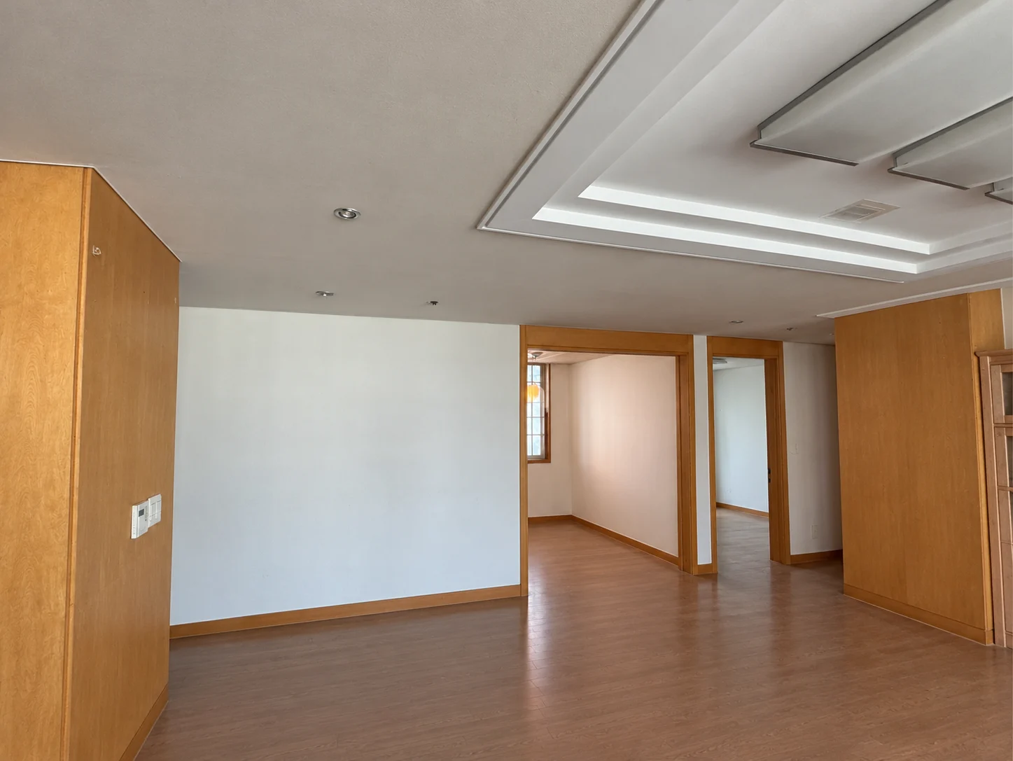 Living room before construction; people, loose belongings and measurements digitally removed