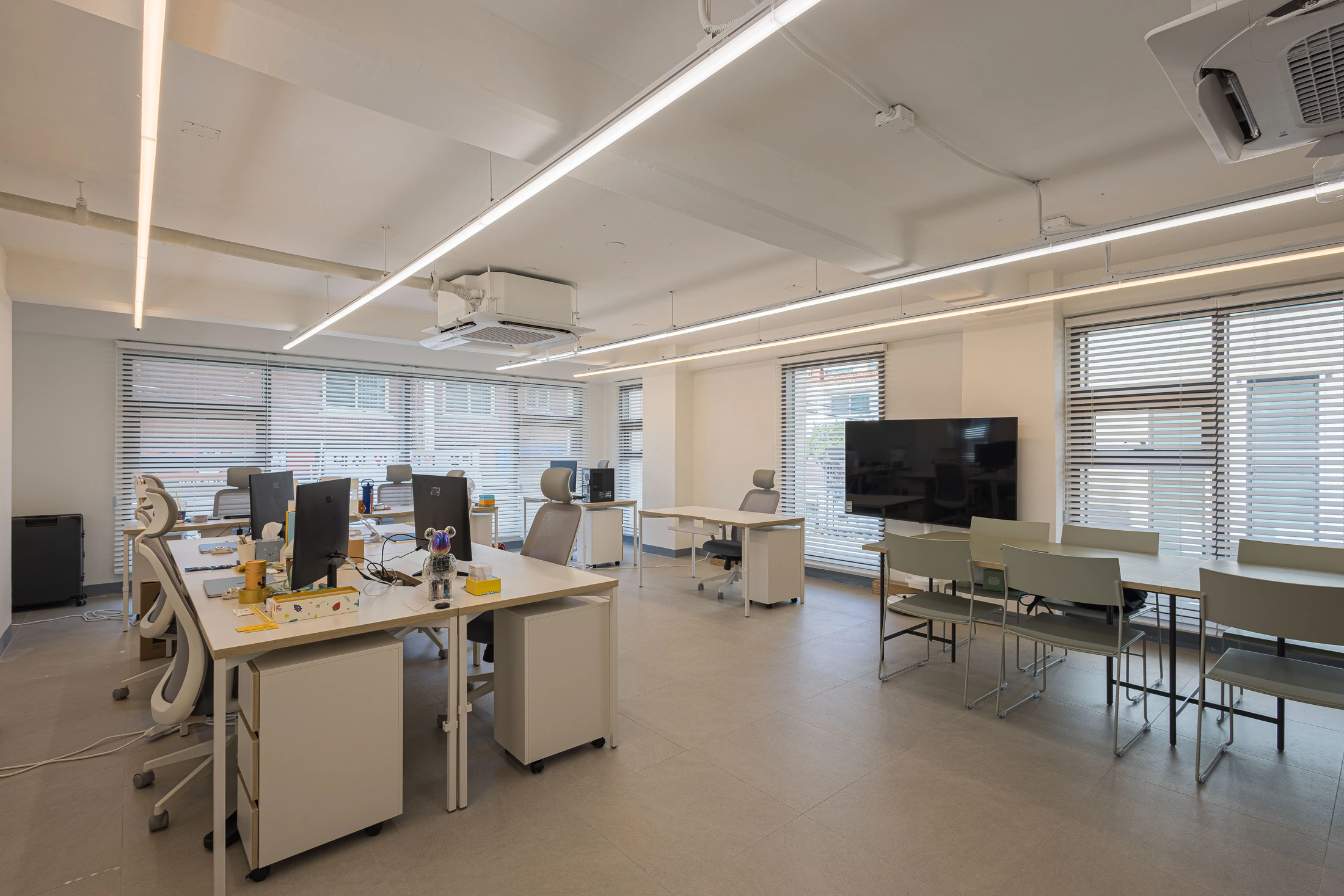 Window-side meeting table and office workstations