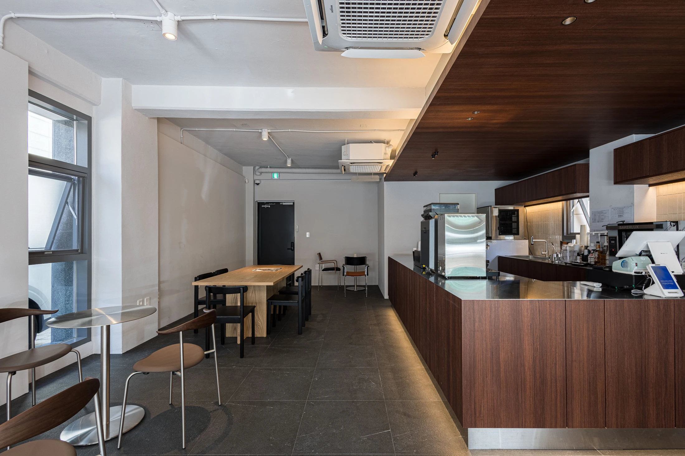 Cafe counter beside the existing window wall and rear entrance
