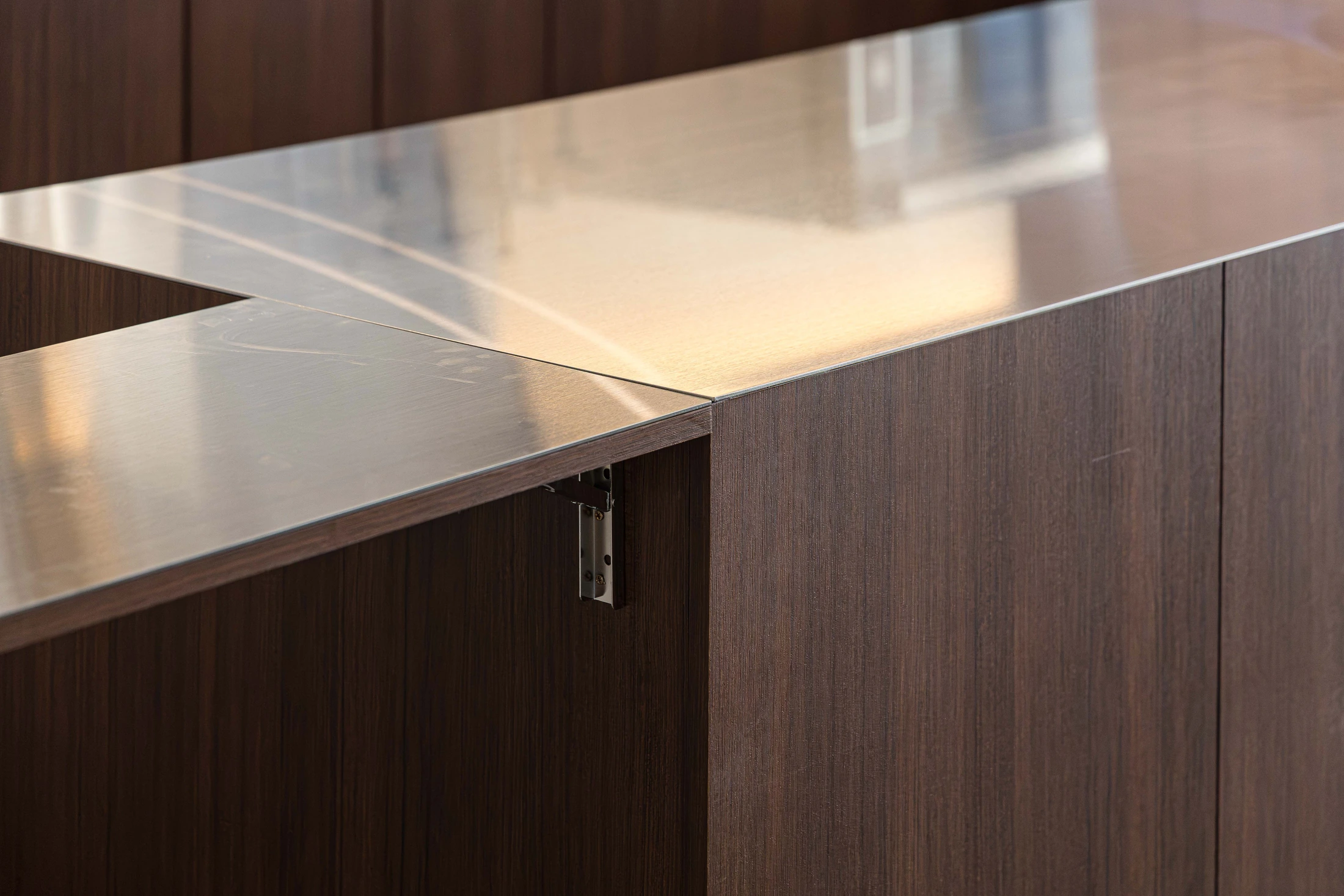 Folded stainless-steel counter and timber panels