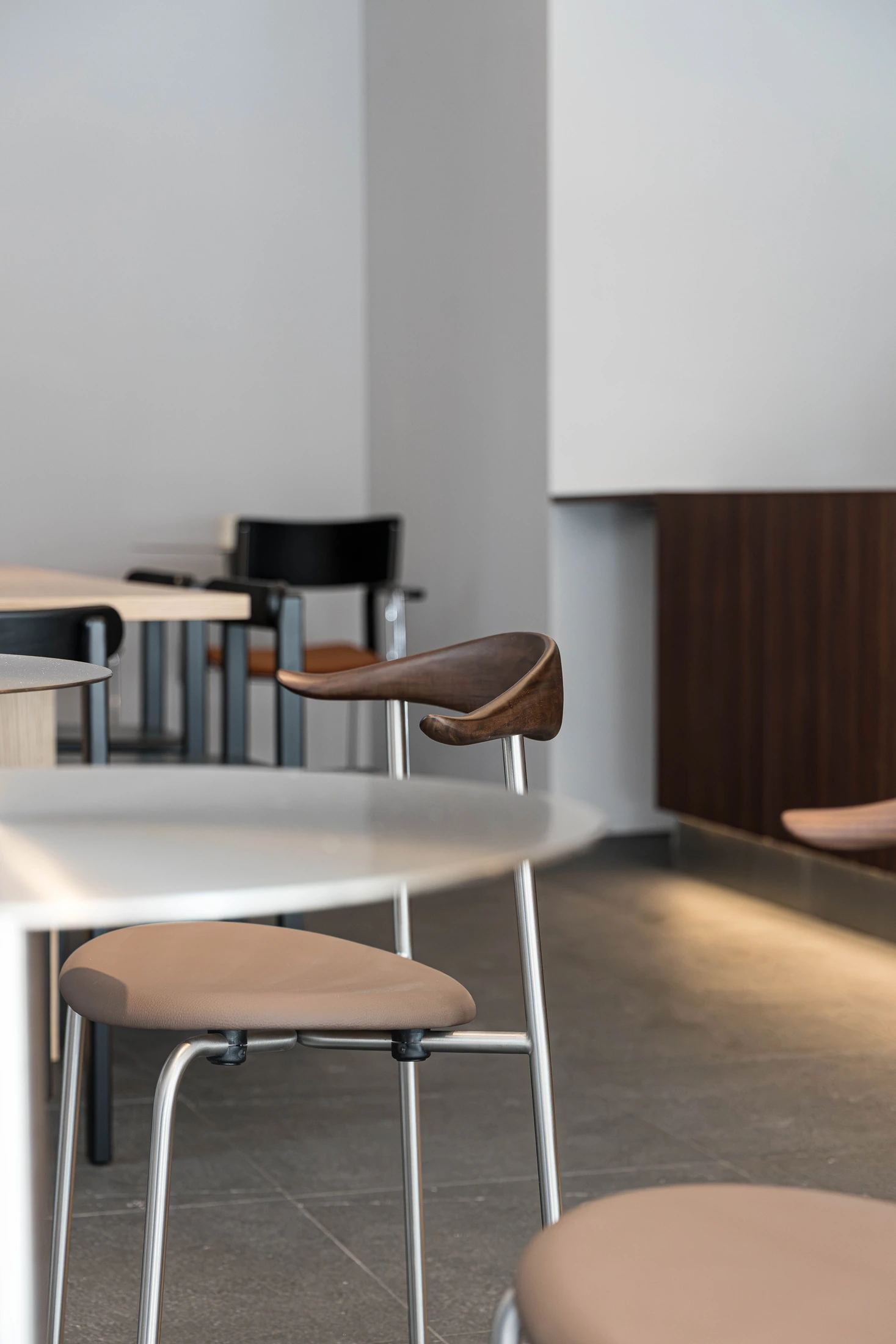 Timber armchairs and circular metal tables