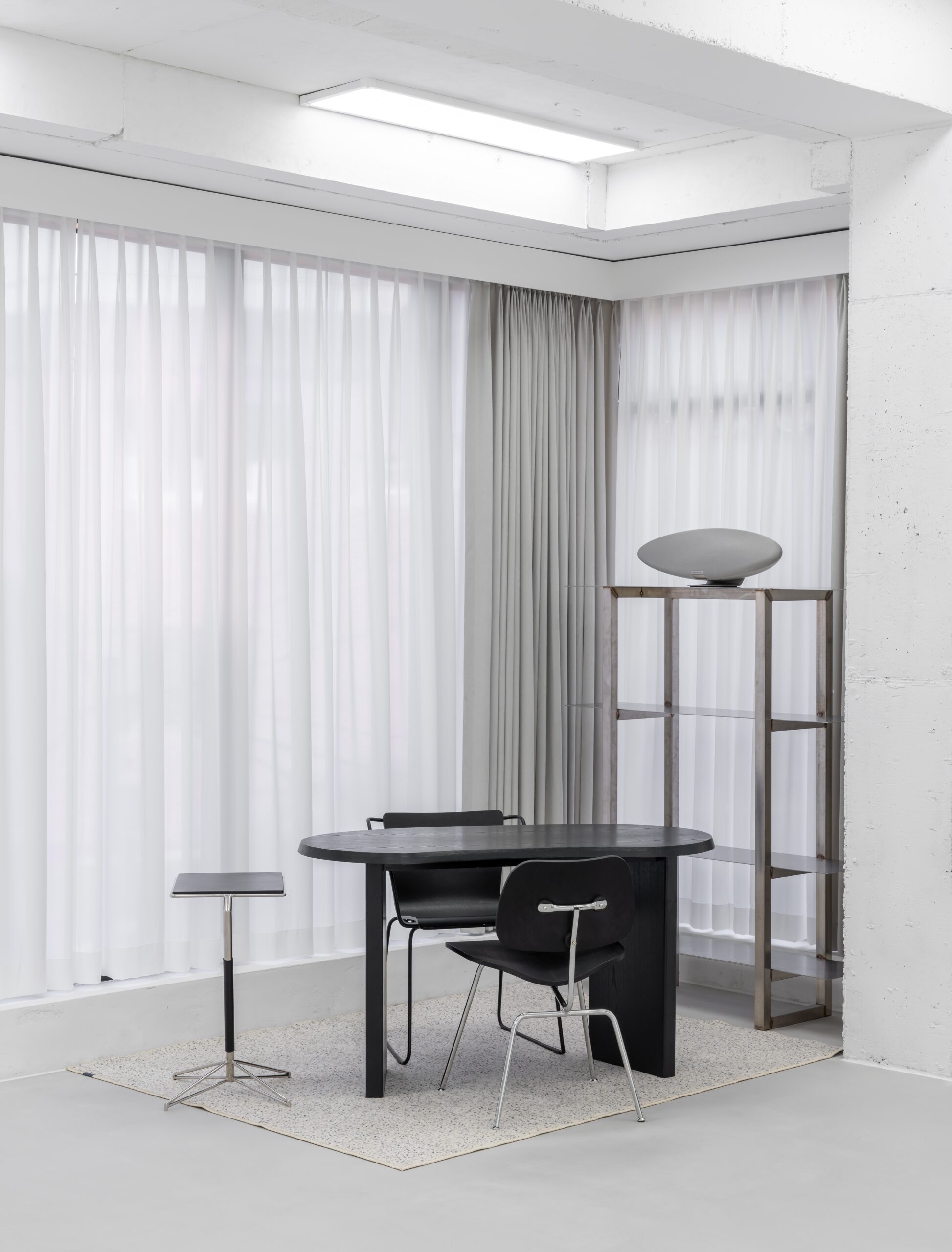 Curtained room, black table and sculptural furniture