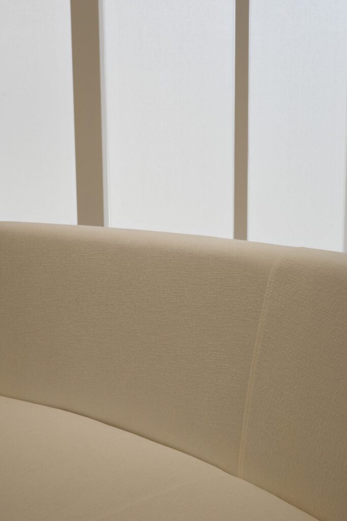 FANU studio — curved ivory sofa and vertical window detail